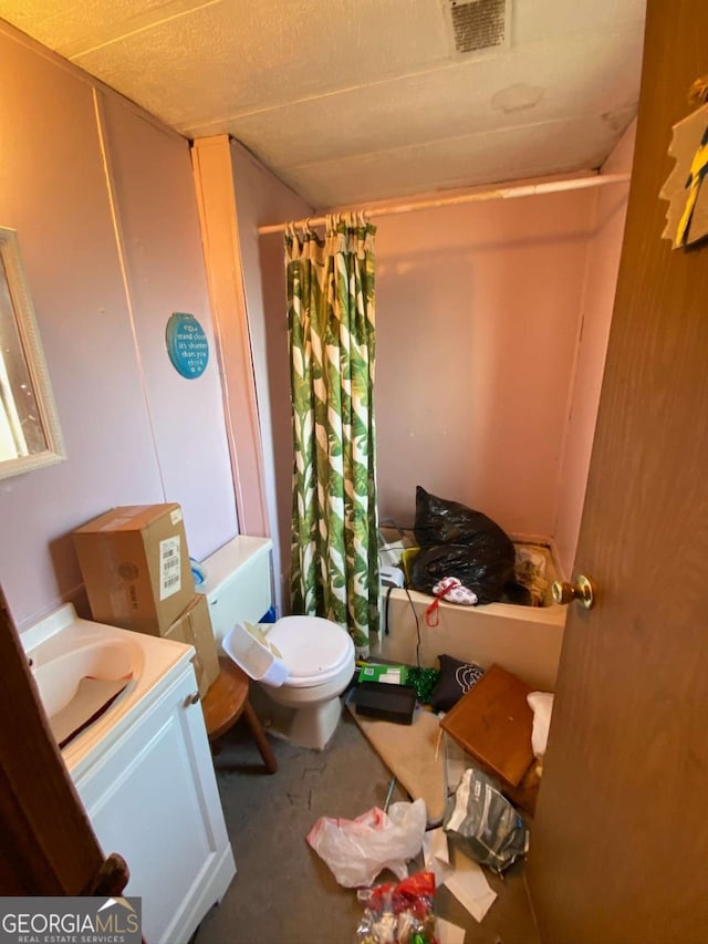 bathroom featuring vanity and toilet