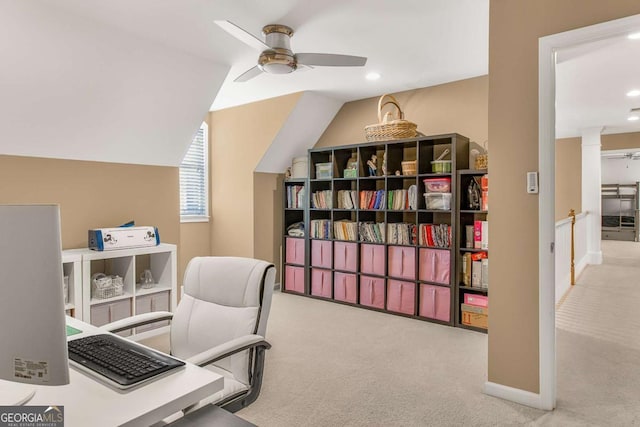 home office featuring lofted ceiling, light colored carpet, and ceiling fan