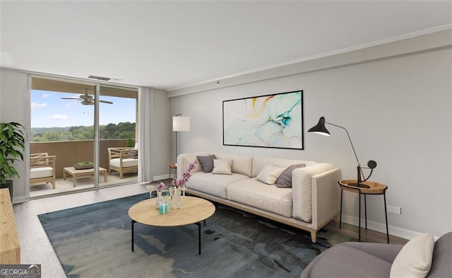 living room with hardwood / wood-style flooring, floor to ceiling windows, and ceiling fan