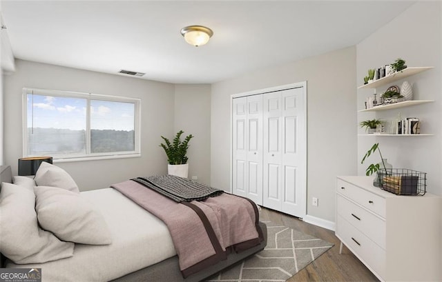 bedroom featuring a closet and dark hardwood / wood-style floors