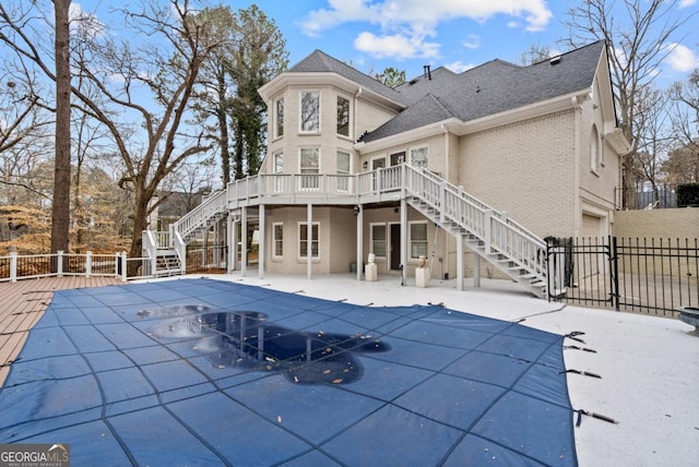 back of house featuring a pool side deck