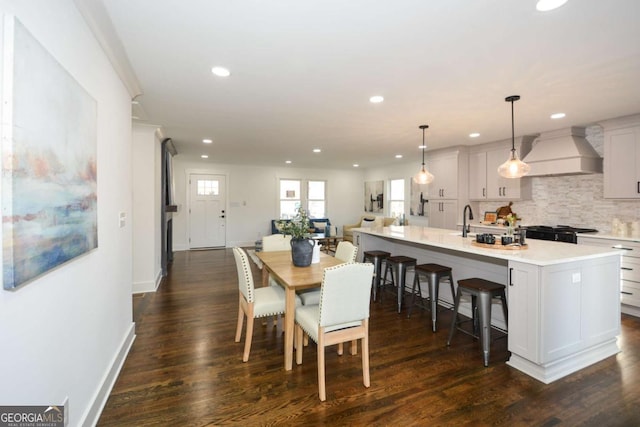 dining space with dark wood-type flooring and sink