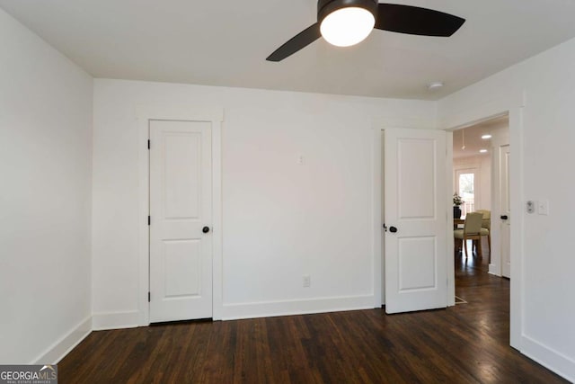 unfurnished bedroom with dark wood-type flooring and ceiling fan