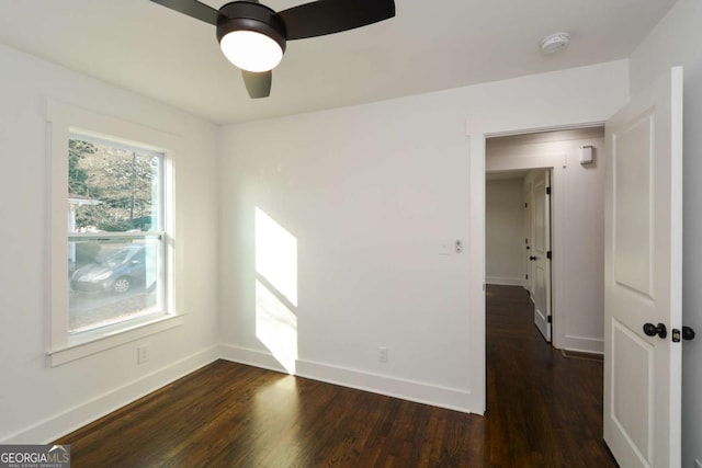 unfurnished room with dark hardwood / wood-style flooring