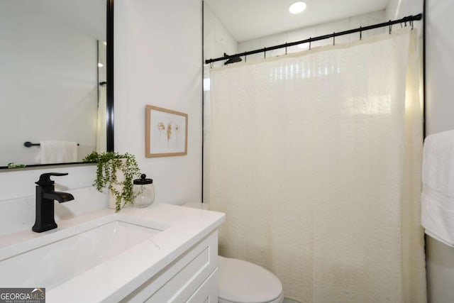 bathroom featuring vanity, a shower with shower curtain, and toilet