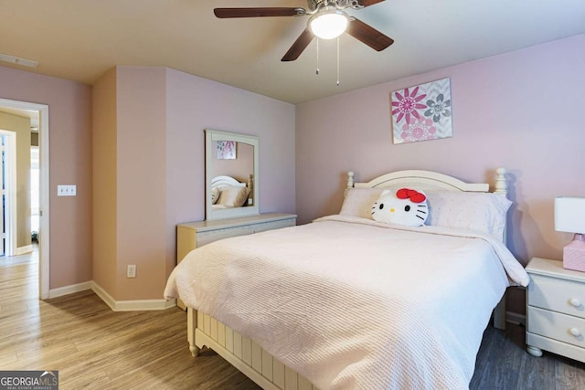 bedroom with ceiling fan and light hardwood / wood-style flooring