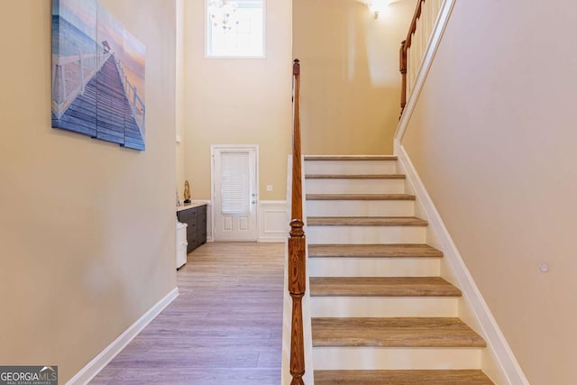 stairs featuring hardwood / wood-style floors