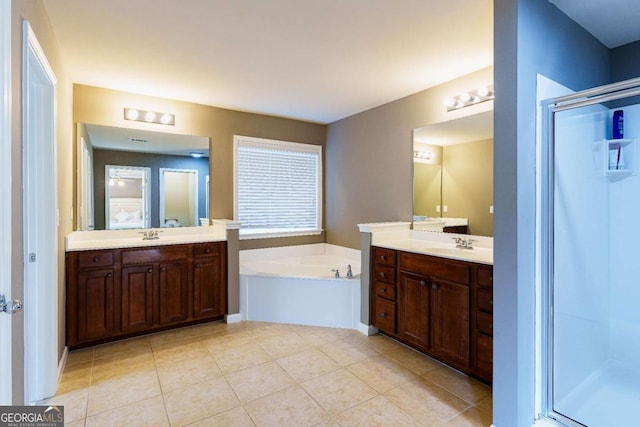 bathroom with independent shower and bath, vanity, and tile patterned floors