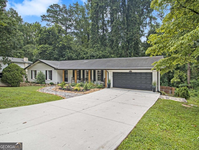 ranch-style home featuring a garage and a front yard