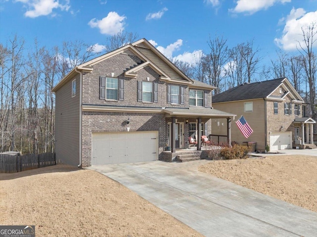 craftsman-style house with covered porch, driveway, brick siding, and a garage