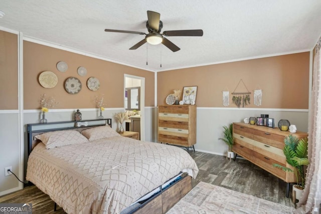 bedroom featuring crown molding, dark wood-type flooring, a textured ceiling, and ceiling fan