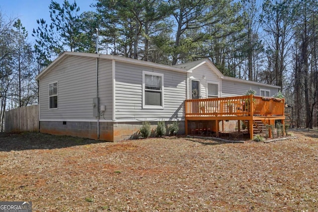 rear view of house with a wooden deck