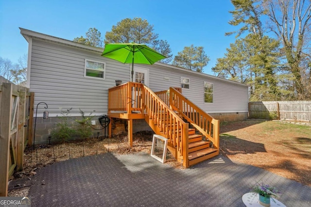 rear view of property featuring a wooden deck