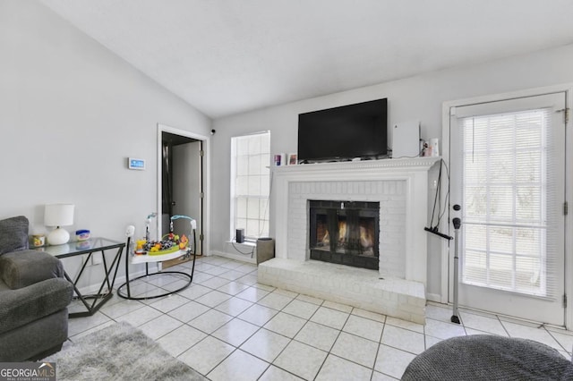 tiled living room featuring lofted ceiling and a fireplace