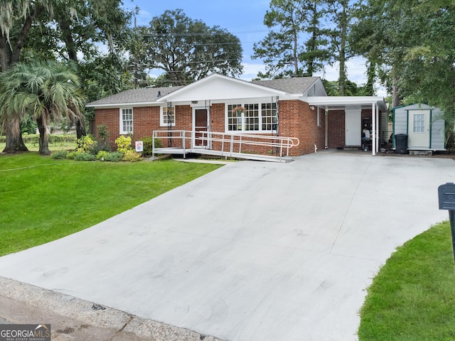 single story home with a carport, a front lawn, and a shed