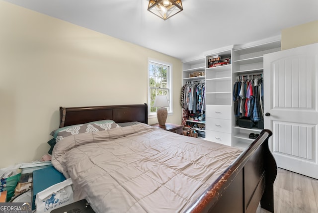 bedroom with light hardwood / wood-style flooring and a closet