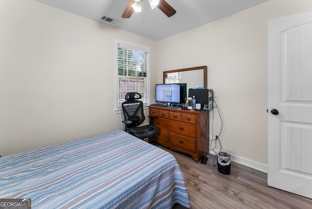 bedroom with ceiling fan and light hardwood / wood-style floors