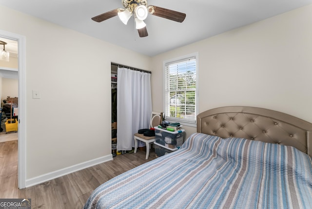 bedroom with ceiling fan and wood-type flooring