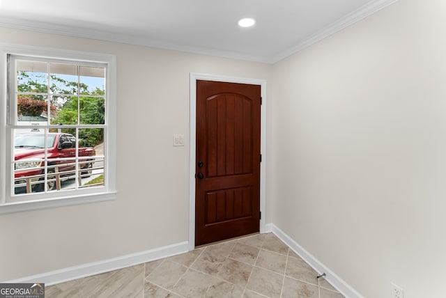 tiled foyer entrance with crown molding