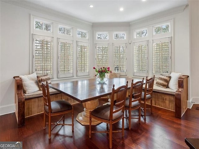 dining space with crown molding and dark hardwood / wood-style floors