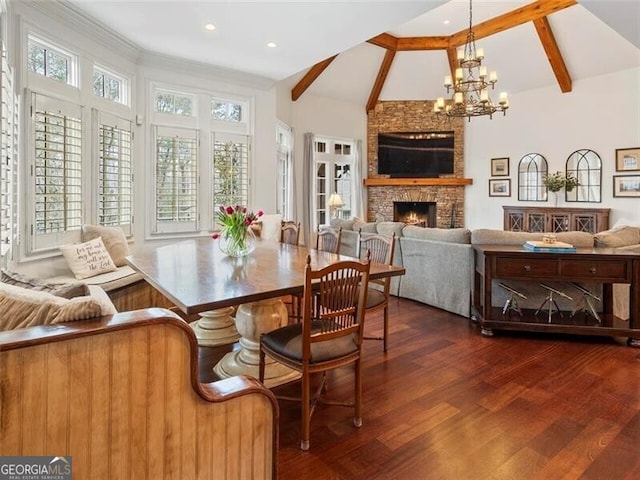 dining room with a fireplace, dark hardwood / wood-style flooring, lofted ceiling with beams, and a notable chandelier