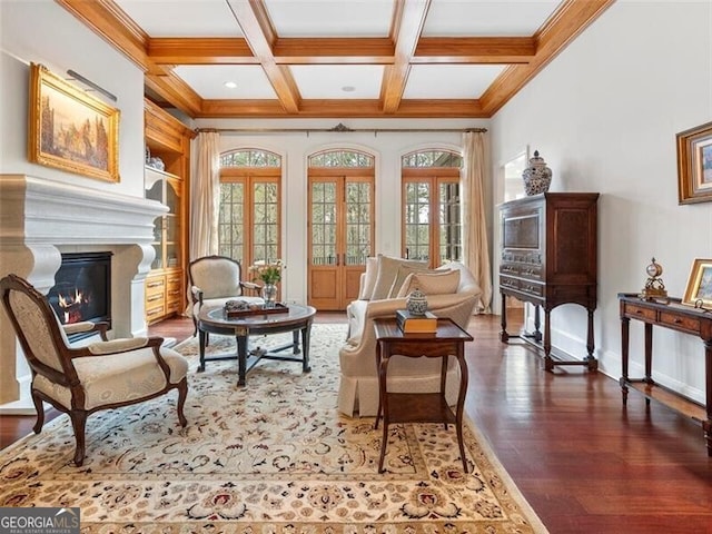 sitting room with coffered ceiling, dark hardwood / wood-style floors, beamed ceiling, and french doors