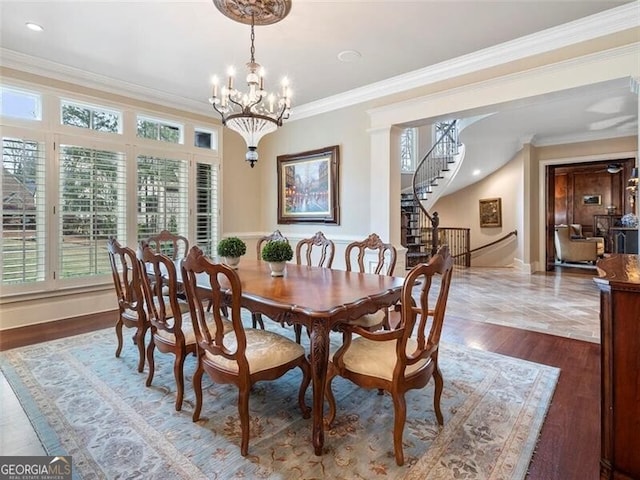 dining area with dark hardwood / wood-style floors, crown molding, a healthy amount of sunlight, and a chandelier