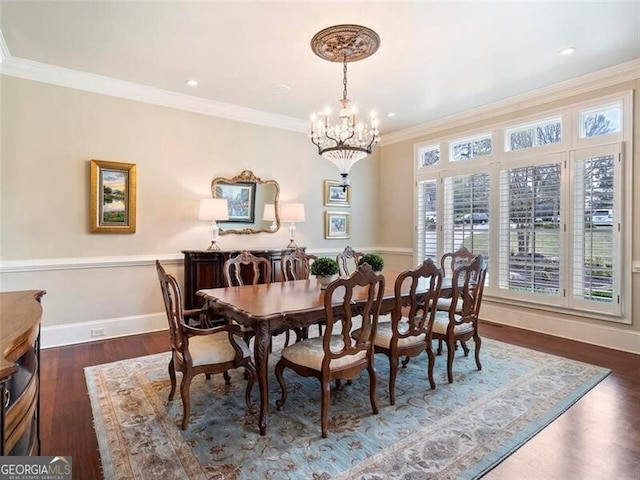 dining space featuring crown molding, a chandelier, and dark hardwood / wood-style flooring