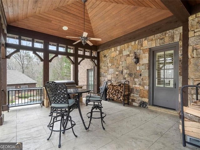 sunroom with lofted ceiling, a healthy amount of sunlight, and wooden ceiling