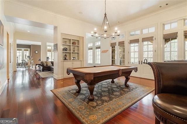 recreation room featuring billiards, french doors, ornamental molding, dark wood-type flooring, and built in shelves