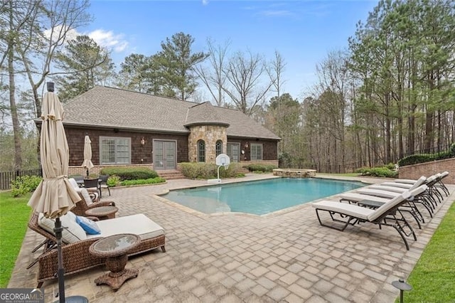 view of swimming pool with a patio