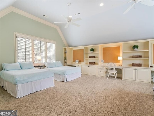 carpeted bedroom with crown molding, built in desk, ceiling fan, and vaulted ceiling