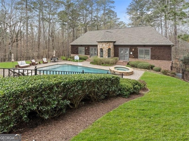 view of pool with an in ground hot tub, a patio, and a lawn