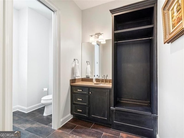 bathroom featuring vanity and toilet