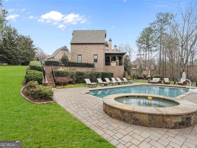 view of swimming pool with an in ground hot tub, a yard, and a patio area