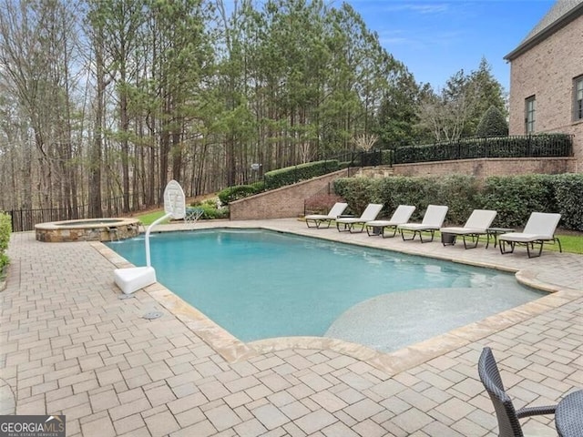 view of pool with an in ground hot tub and a patio area