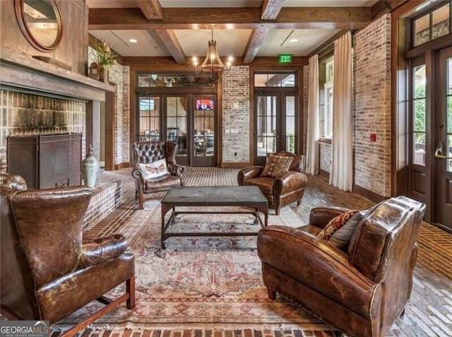 sitting room featuring french doors, brick wall, beam ceiling, and a notable chandelier