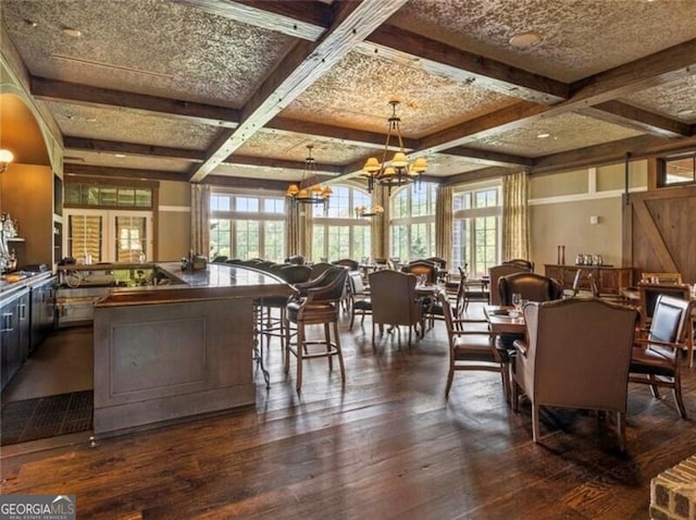 dining area featuring coffered ceiling, dark hardwood / wood-style flooring, a chandelier, and beam ceiling