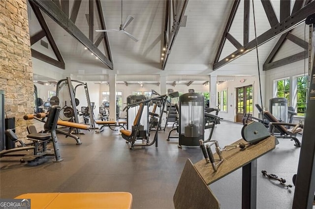 workout area featuring high vaulted ceiling and decorative columns