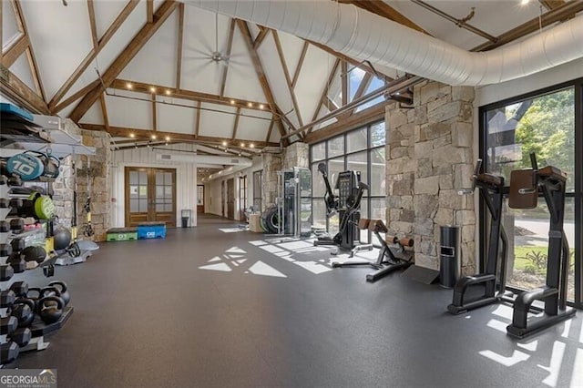 exercise room with high vaulted ceiling