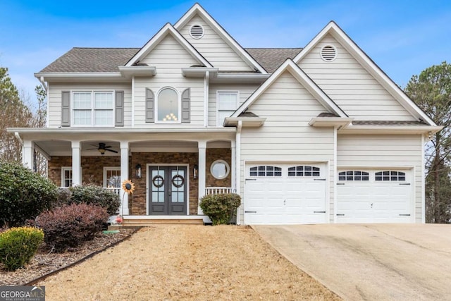 view of front of home with covered porch, french doors, and a garage