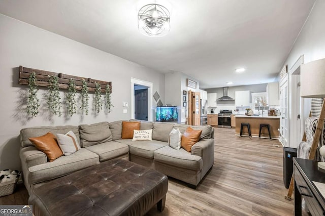 living room featuring sink and light wood-type flooring