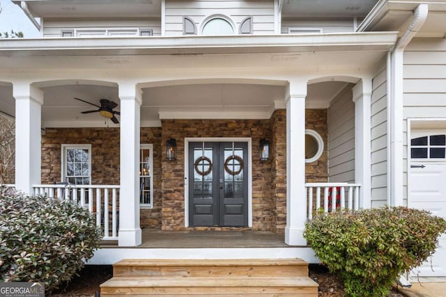 entrance to property featuring french doors, ceiling fan, and a porch