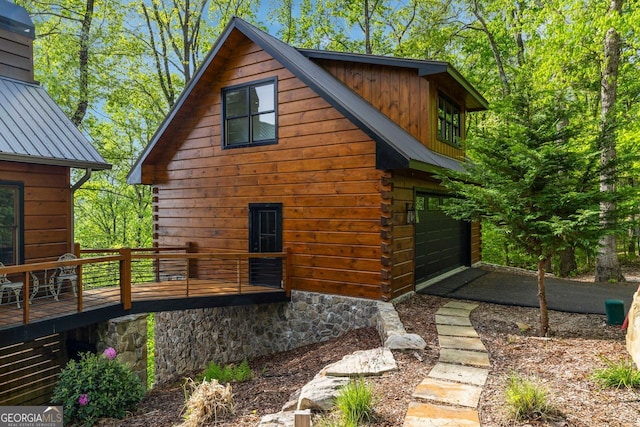 851 Moreland Dr N, Blue Ridge, GA 30513 - view of property exterior featuring a garage, a deck, and metal roof