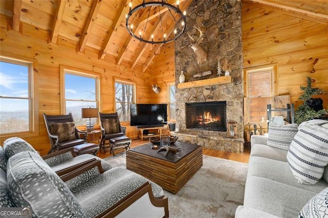 851 Moreland Dr N, Blue Ridge, GA 30513 - living area with an inviting chandelier, a stone fireplace, wooden ceiling, vaulted ceiling with beams, and wood finished floors