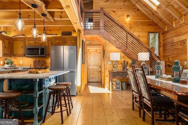 851 Moreland Dr N, Blue Ridge, GA 30513 - dining room with wood walls, light wood-style floors, stairway, vaulted ceiling with beams, and wood ceiling