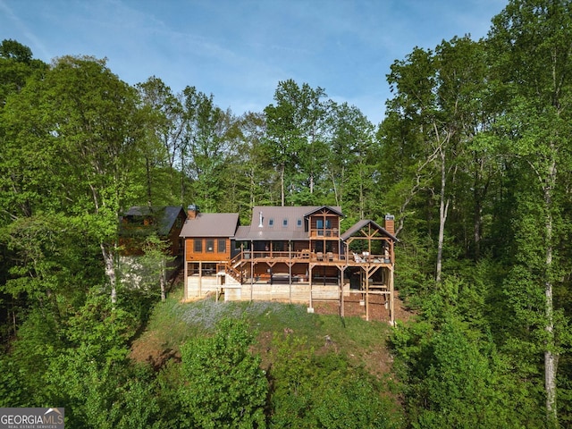 851 Moreland Dr N, Blue Ridge, GA 30513 - rear view of house featuring a chimney, a wooded view, and a deck