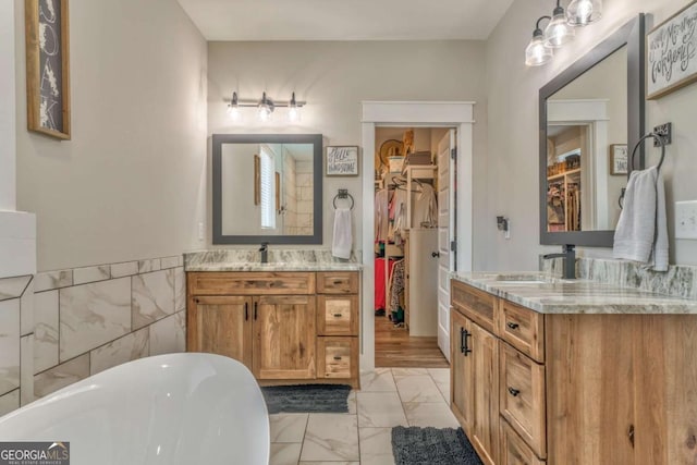 bathroom with vanity and a washtub