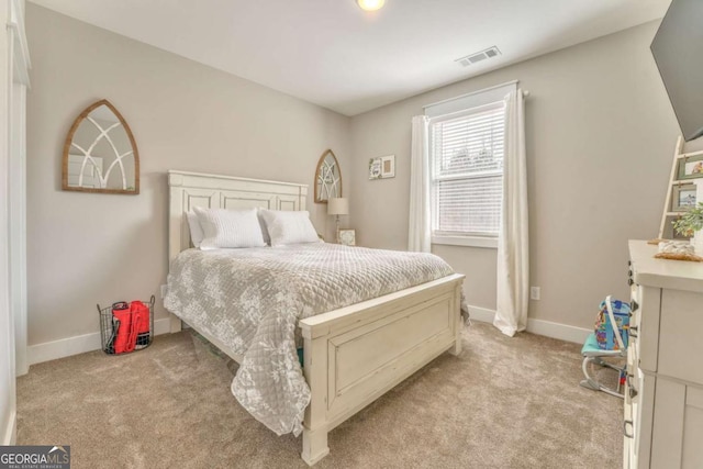 bedroom featuring light carpet