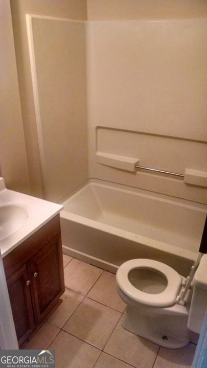 full bathroom featuring tile patterned floors, toilet, shower / bath combination, and vanity